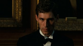 Movie still from “Chariots of Fire” (1981), directed by Hugh Hudson – A man in a suit and bow tie; Close Up shot, Low angle