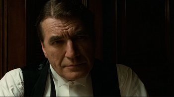 Movie still from “Chariots of Fire” (1981), directed by Hugh Hudson – A person wearing a suit and tie; Close Up shot, Low angle