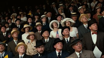Movie still from “Chariots of Fire” (1981), directed by Hugh Hudson – A group of people wearing hats and suits and ties; Medium shot, High angle
