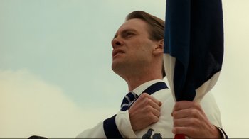Movie still from “Chariots of Fire” (1981), directed by Hugh Hudson – A person holding a flag; Close Up shot, Low angle
