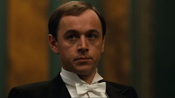 Movie still from “Chariots of Fire” (1981), directed by Hugh Hudson – A person wearing a suit and bow tie; Close Up shot, Low angle