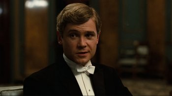 Movie still from “Chariots of Fire” (1981), directed by Hugh Hudson – A man wearing a tuxedo and bow tie; Close Up shot, High angle