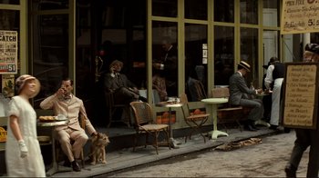 Movie still from “Chariots of Fire” (1981), directed by Hugh Hudson – A group of people sitting outside of a restaurant; Wide shot, High angle