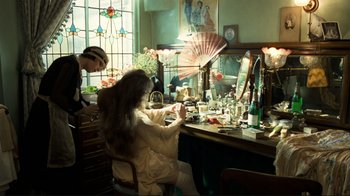 Movie still from “Chariots of Fire” (1981), directed by Hugh Hudson – A woman sitting in front of a mirror in a room; Medium shot, Over the shoulder angle