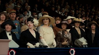 Movie still from “Chariots of Fire” (1981), directed by Hugh Hudson – A group of women in hats are sitting in a crowd; Medium shot, Low angle