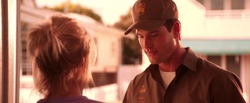 Movie still from “Charlie's Angels” (2000), directed by McG – A ups worker talking to a woman outside of a house; Medium shot, Low angle