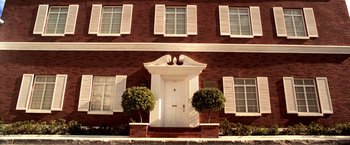 Movie still from “Charlie's Angels” (2000), directed by McG – A white front door of a red brick house; Extreme Wide shot, Low angle
