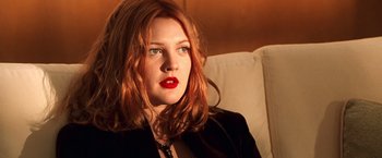 Movie still from “Charlie's Angels” (2000), directed by McG – A woman sitting on a couch with red hair; Close Up shot, Low angle