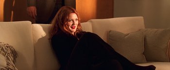 Movie still from “Charlie's Angels” (2000), directed by McG – A beautiful woman with red hair laying on a couch; Medium shot, Low angle