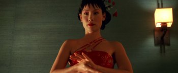Movie still from “Charlie's Angels” (2000), directed by McG – A woman in a red dress with her hands crossed; Close Up shot, Low angle