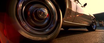 Movie still from “Charlie's Angels” (2000), directed by McG – View of the wheel of an old car; Extreme Close Up shot, Low angle