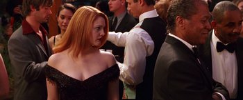 Movie still from “Charlie's Angels” (2000), directed by McG – A woman in a black dress is standing next to a man in a white shirt; Medium shot, Over the shoulder angle