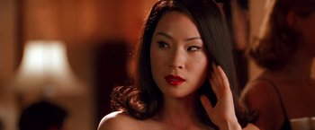 Movie still from “Charlie's Angels” (2000), directed by McG – A beautiful woman with long black hair and red lipstick; Close Up shot, Over the shoulder angle