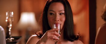 Movie still from “Charlie's Angels” (2000), directed by McG – A woman holding a glass of wine in her hand; Close Up shot, Low angle