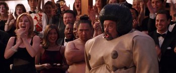 Movie still from “Charlie's Angels” (2000), directed by McG – A group of people standing in front of a group of people; Medium shot, Over the shoulder angle