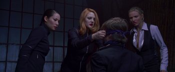 Movie still from “Charlie's Angels” (2000), directed by McG – Two women and a man are blindfolded; Medium shot, Over the shoulder angle