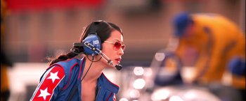 Movie still from “Charlie's Angels” (2000), directed by McG – A woman wearing a blue jacket and a headset; Close Up shot, Low angle