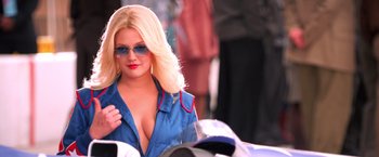 Movie still from “Charlie's Angels” (2000), directed by McG – A woman in a blue shirt and sunglasses is standing next to a motorcycle; Close Up shot, Over the shoulder angle