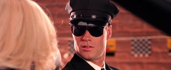 Movie still from “Charlie's Angels” (2000), directed by McG – A man wearing a black hat and sunglasses; Close Up shot, Low angle