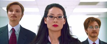 Movie still from “Charlie's Angels” (2000), directed by McG – A person wearing glasses and a suit; Close Up shot, Low angle