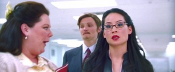 Movie still from “Charlie's Angels” (2000), directed by McG – A woman in a business suit and a man in a business suit; Close Up shot, Over the shoulder angle