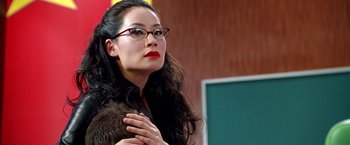 Movie still from “Charlie's Angels” (2000), directed by McG – A woman with long black curly hair wearing glasses and holding her hands up; Close Up shot, Low angle