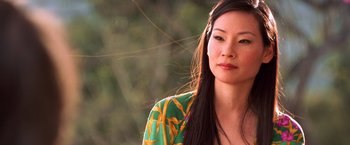 Movie still from “Charlie's Angels” (2000), directed by McG – A woman with long black hair wearing a green and yellow shirt; Close Up shot, High angle