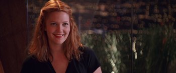 Movie still from “Charlie's Angels” (2000), directed by McG – A woman with red hair smiling for the camera; Close Up shot, Over the shoulder angle