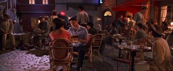Movie still from “Charlie's Angels” (2000), directed by McG – A man and a woman are sitting at a table in a restaurant; Wide shot, High angle