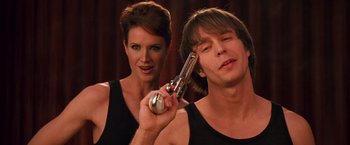 Movie still from “Charlie's Angels” (2000), directed by McG – A woman and a man are holding a gun in their hands; Close Up shot, Low angle