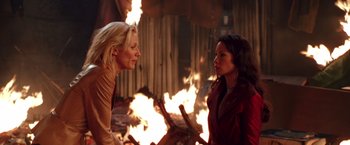 Movie still from “Charlie's Angels” (2000), directed by McG – Two women standing in front of a fire pit; Medium shot, Over the shoulder angle