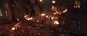 Movie still from “Charlie's Angels” (2000), directed by McG – Two people are standing in the middle of a room that is burned; Extreme Wide shot, Overhead angle