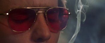 Movie still from “Charlie's Angels” (2000), directed by McG – A person wearing a pair of red sunglasses; Extreme Close Up shot, Low angle