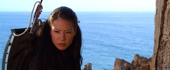 Movie still from “Charlie's Angels” (2000), directed by McG – A woman standing next to a body of water; Close Up shot, High angle
