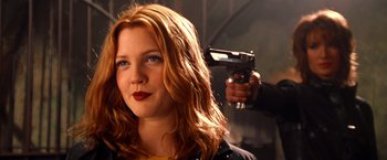 Movie still from “Charlie's Angels” (2000), directed by McG – A woman holding a gun up to her face; Close Up shot, Low angle