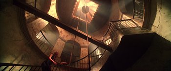 Movie still from “Charlie's Angels” (2000), directed by McG – Looking up at a spiral staircase in an old building; Extreme Wide shot, Low angle