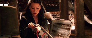 Movie still from “Charlie's Angels” (2000), directed by McG – A young woman is working on a laptop; Close Up shot, High angle