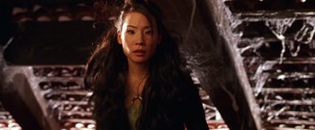 Movie still from “Charlie's Angels” (2000), directed by McG – A woman with long black hair is posing for a picture; Close Up shot, Low angle