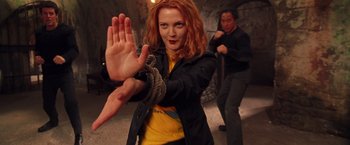 Movie still from “Charlie's Angels” (2000), directed by McG – A woman with red hair and a rope around her neck; Medium shot, Low angle