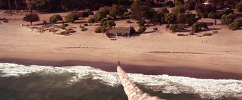 Movie still from “Charlie's Angels” (2000), directed by McG – An aerial view of a beach with a person standing on the beach; Extreme Wide shot, High angle