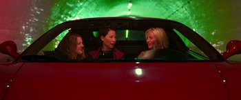 Movie still from “Charlie's Angels” (2000), directed by McG – A group of women sitting in the back of a red car; Medium shot, Low angle