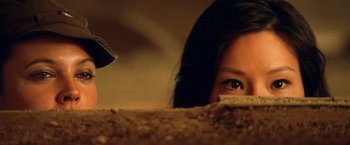 Movie still from “Charlie's Angels: Full Throttle” (2003), directed by McG – A woman's face as she peeks over the edge of a bed; Extreme Close Up shot, Low angle