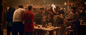 Movie still from “Charlie's Angels: Full Throttle” (2003), directed by McG – A group of people standing around a table with drinks; Wide shot, High angle