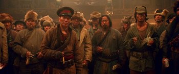 Movie still from “Charlie's Angels: Full Throttle” (2003), directed by McG – A group of men standing next to each other in a room; Medium shot, Low angle