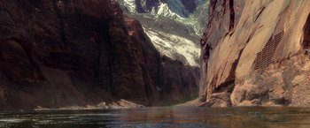Movie still from “Charlie's Angels: Full Throttle” (2003), directed by McG – A river flowing through a canyon with mountains in the background; Extreme Wide shot, High angle