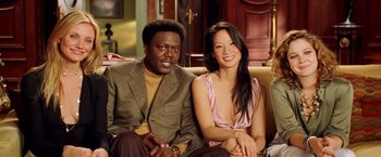 Movie still from “Charlie's Angels: Full Throttle” (2003), directed by McG – A man and a woman sitting next to each other on a couch; Medium shot, High angle