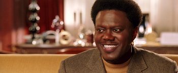 Movie still from “Charlie's Angels: Full Throttle” (2003), directed by McG – A person wearing a suit and smiling; Close Up shot, High angle