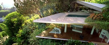 Movie still from “Charlie's Angels: Full Throttle” (2003), directed by McG – A small house in the middle of a lush green forest; Extreme Wide shot, High angle