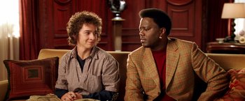 Movie still from “Charlie's Angels: Full Throttle” (2003), directed by McG – Two men are sitting on a couch and one of them is talking to another man; Close Up shot, Over the shoulder angle