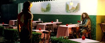 Movie still from “Charlie's Angels: Full Throttle” (2003), directed by McG – Tables and chairs are set up outside in a restaurant; Wide shot, Over the shoulder angle